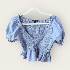 Blue Smocked Puff Sleeve Top by the brand Cotton Candy LA deep v neck cropped
